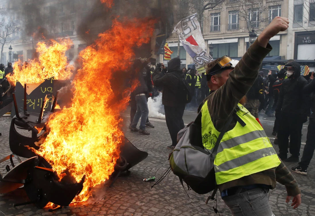 Luxury stores, restaurants and banks on the Champs-Elysees assessed damage Sunday after they were ransacked or blackened by life-threatening fires. (AP)