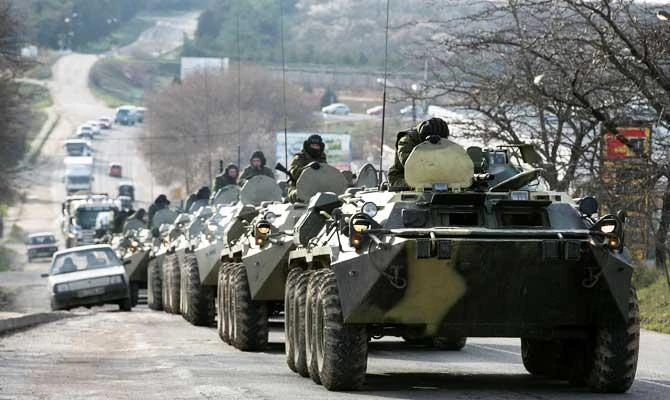 Soldiers, believed to be Russian, ride on military armoured personnel carriers on a road near the Crimean port city of Sevastopol March 10, 2014. (REUTERS)