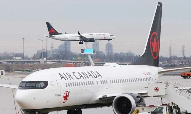 An Air Canada Boeing 737 MAX 8 from San Francisco approaches for landing at Toronto Pearson International Airport over a parked Air Canada Boeing 737 MAX 8 aircraft in Toronto, Ontario, Canada, March 13, 2019. (REUTERS)