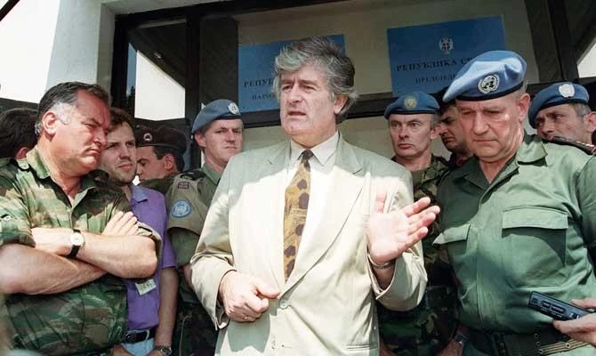 In this file photo taken on August 5, 1993 Radovan Karadzic (C), the Bosnian Serb warlord and leader of the Serb-run part of Bosnia during the 1992-1995 war, addresses the media in his stronghold of Pale. (AFP)