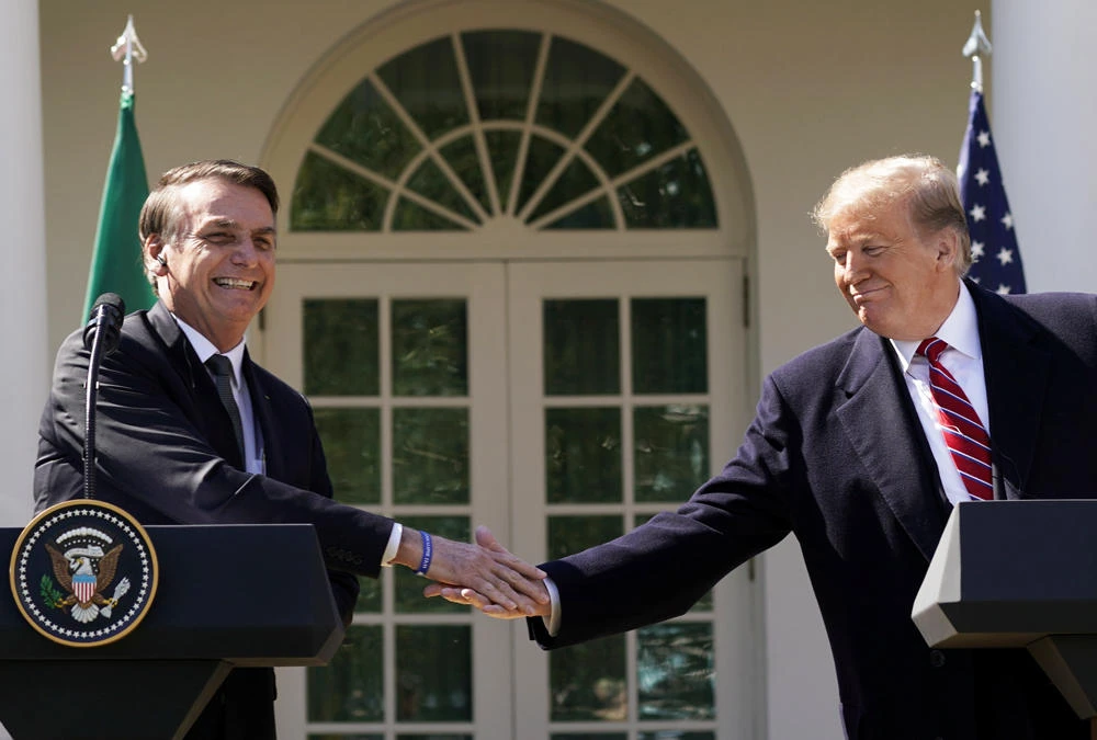 Brazil’s President Jair Bolsonaro shakes hands with US President Donald Trump at the conclusion of a joint news conference in the Rose Garden of the White House in Washington, US, on March 19, 2019. (REUTERS/Kevin Lamarque)