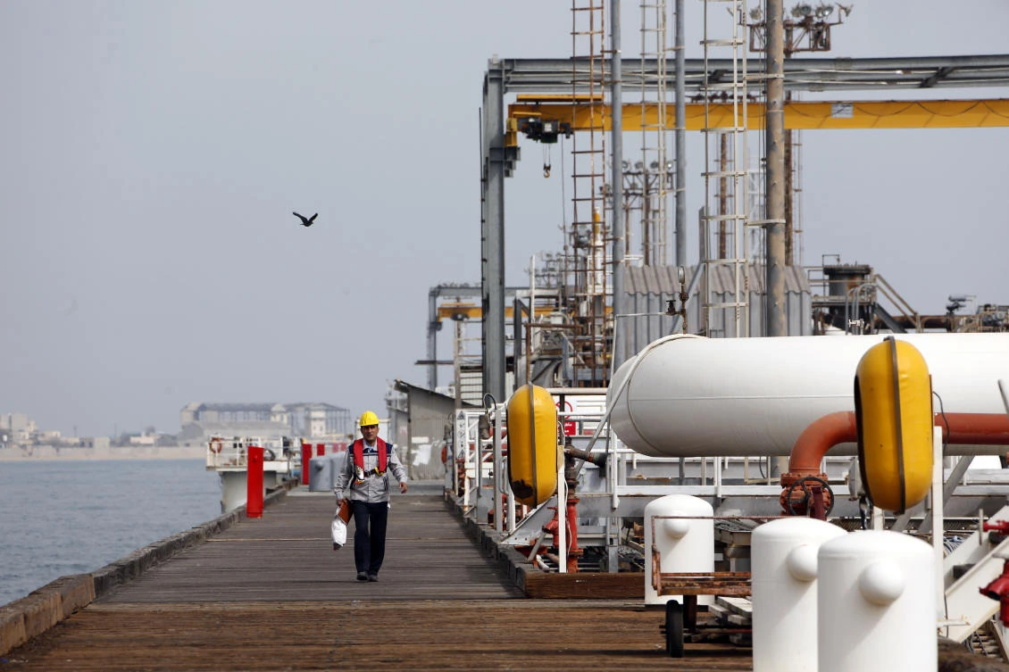 An Iranian labourer walks on an oil facility platform in the Khark Island, on the shore of the Gulf. (AFP)