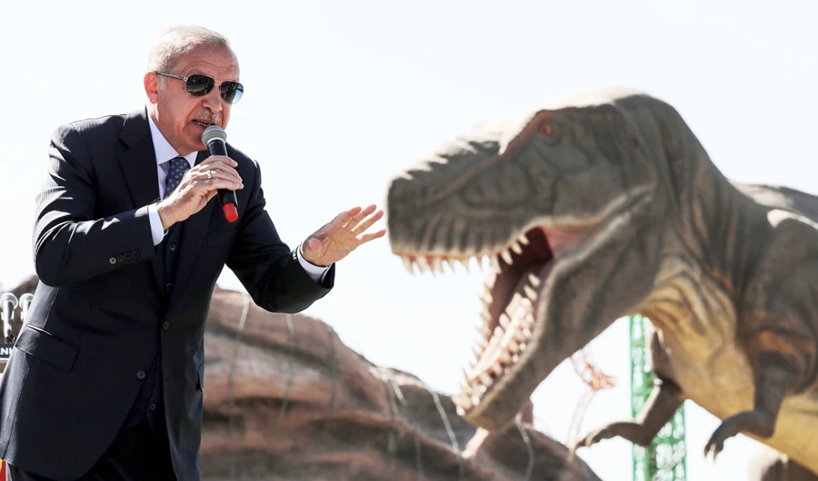 Turkish President Recep Tayyip Erdogan delivers a speech next to a model dinosaur during the opening ceremony of the Wonderland Eurasia theme park in Ankara. (AFP / Adem Altan)