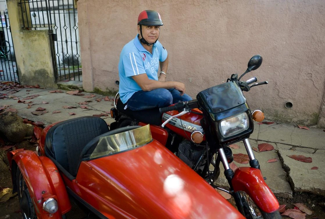 Restaurateur Alejandro Prohenza Hernandez says his pampered red 30-year-old Jawa 350 is like a second child. (AFP)