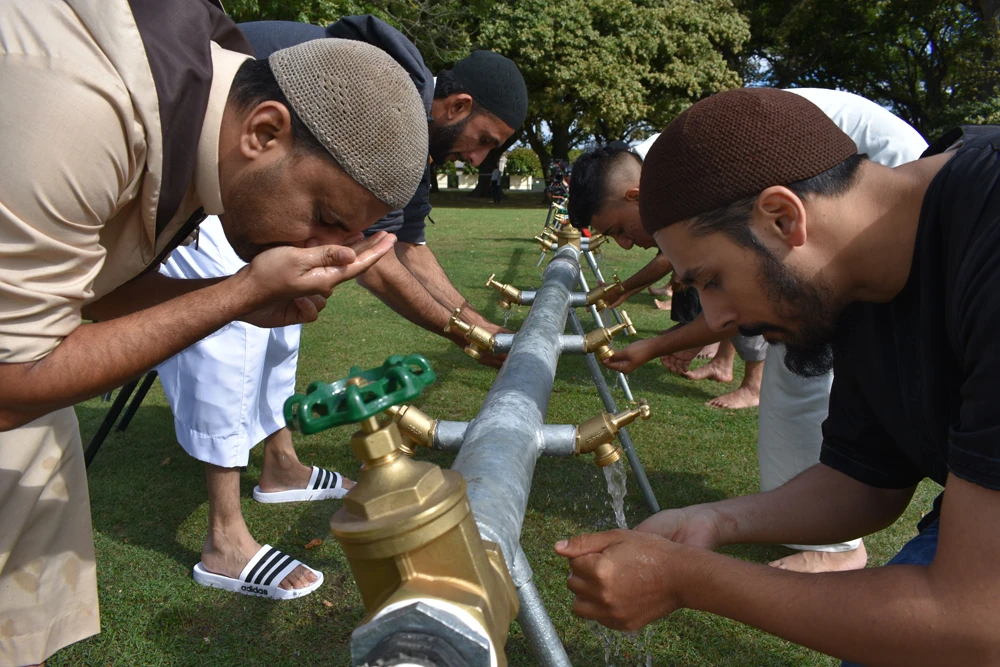 Wash stations have been set up for men to prepare for Friday Prayers in Hagley Park, Christchurch. (AN photo by Daniel Nielsen)
