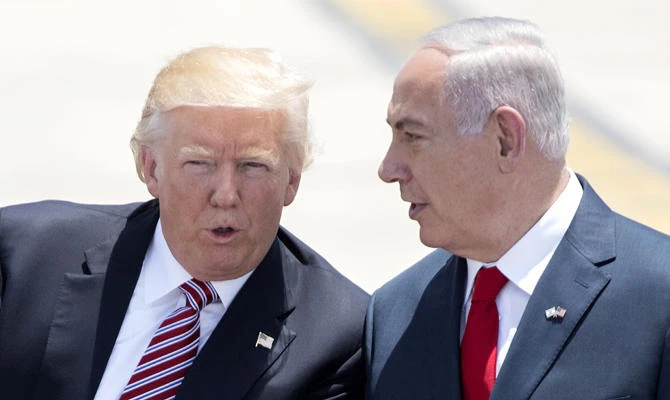 In this file photo taken on May 22, 2017, Israeli Prime Minister Benjamin Netanyahu (R) and US President Donald Trump speak upon the latter's arrival at Ben Gurion International Airport in Tel Aviv. (AFP)