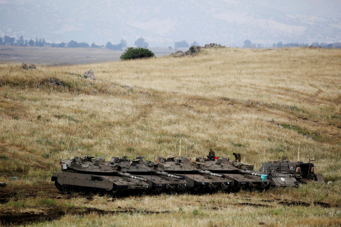 Israeli soldiers stand on tanks near the Israeli side of the border with Syria in the Israeli-occupied Golan Heights, Israel May 9, 2018. (Reuters)