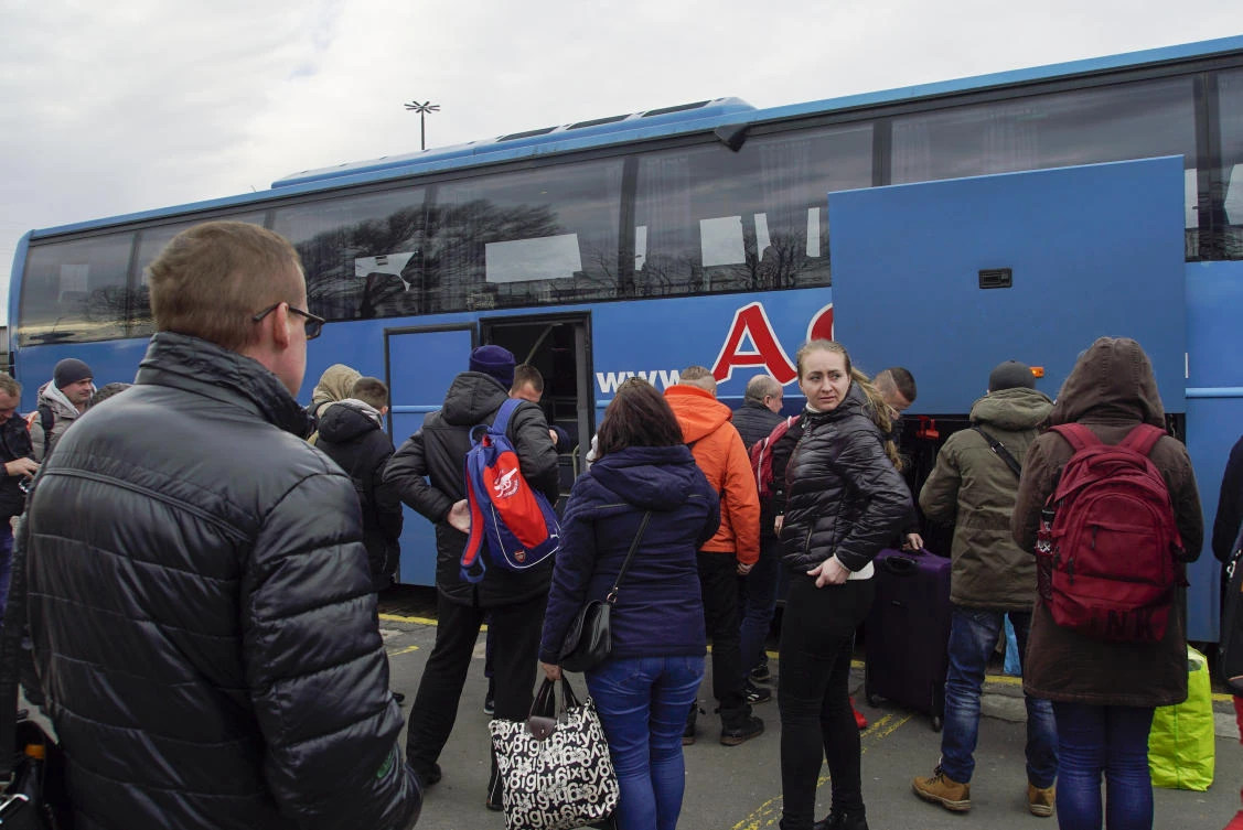 Some 1.2 million Ukrainians now work in Poland, where average wages are about three times higher than back home. Above, Ukrainians disembark the Kharkiv-Warsaw bus in Warsaw. (AP)