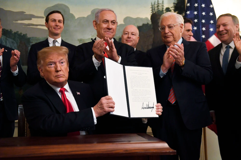 President Donald Trump holds up a signed proclamation recognizing Israel's sovereignty over the Golan Heights, as Israeli Prime Minister Benjamin Netanyahu looks on in the Diplomatic Reception Room of the White House. (AP)
