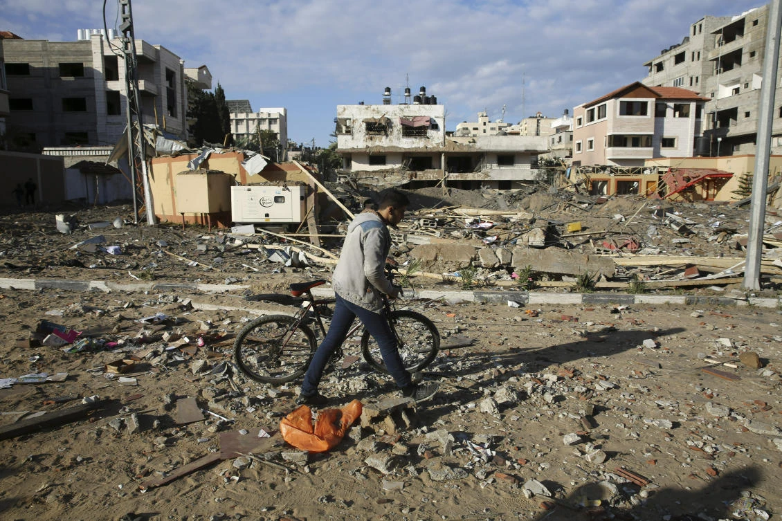 A Palestinian man walks on the damage of the offices of Hamas leader Ismail Haniyeh, in Gaza City, Tuesday, March 26, 2019. (AP)