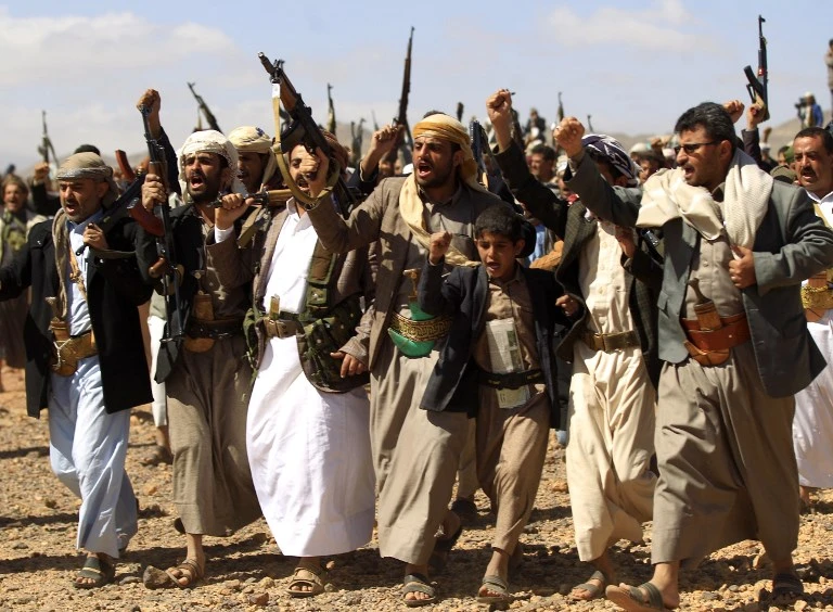 In this file photo taken on February 21, 2019 armed Yemeni men raise their weapons as they gather near the capital Sanaa to show their support to the Houthis. (File/AFP)
