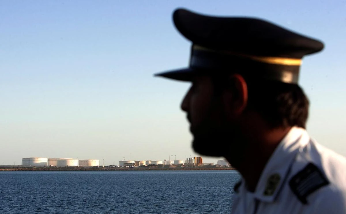 A security personnel looks on at oil docks at the port of Kalantari in the city of Chabahar, 300km (186 miles) east of the Strait of Hormuz, Iran January 17, 2012.(Reuters)