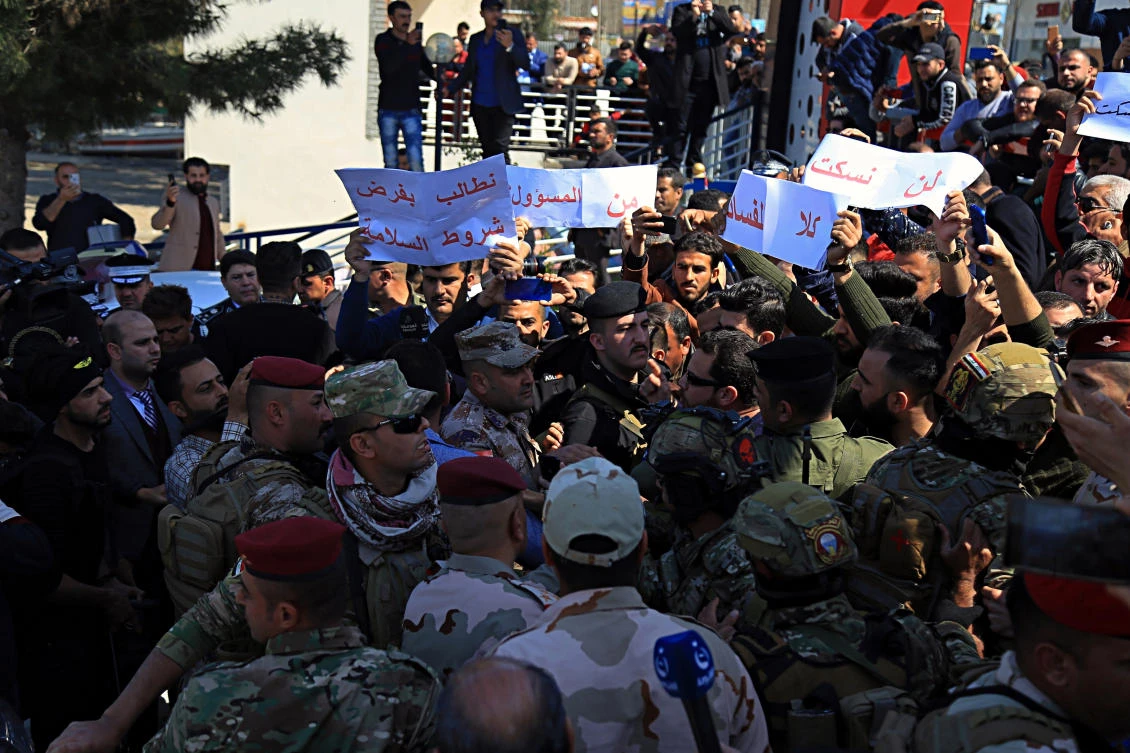 Angry relatives of victims the sunken ferry blocked a road where Iraq’s presidential and Mosul’s Governor convoy was passing, chanting “no to corruption” and pelting the provincial governor’s car with stones in protest in Mosul, Iraq, Friday, March 22, 2019. (File/AP)