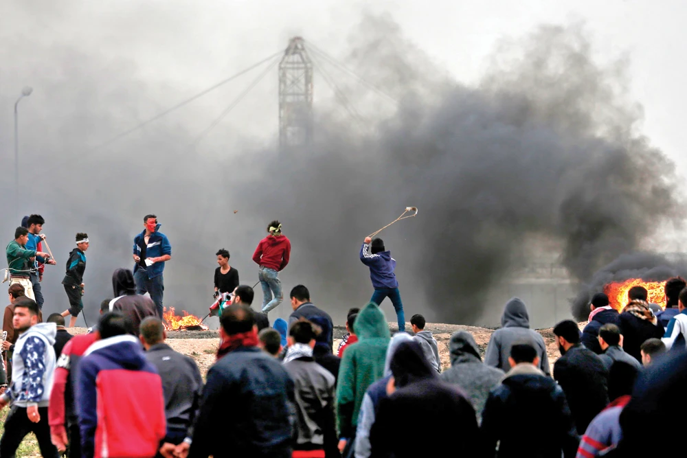 Israeli forces have killed dozens of Palestinians in border protests over the past year, and they shot dead three on Saturday, with more than 240 injured. (AFP)
