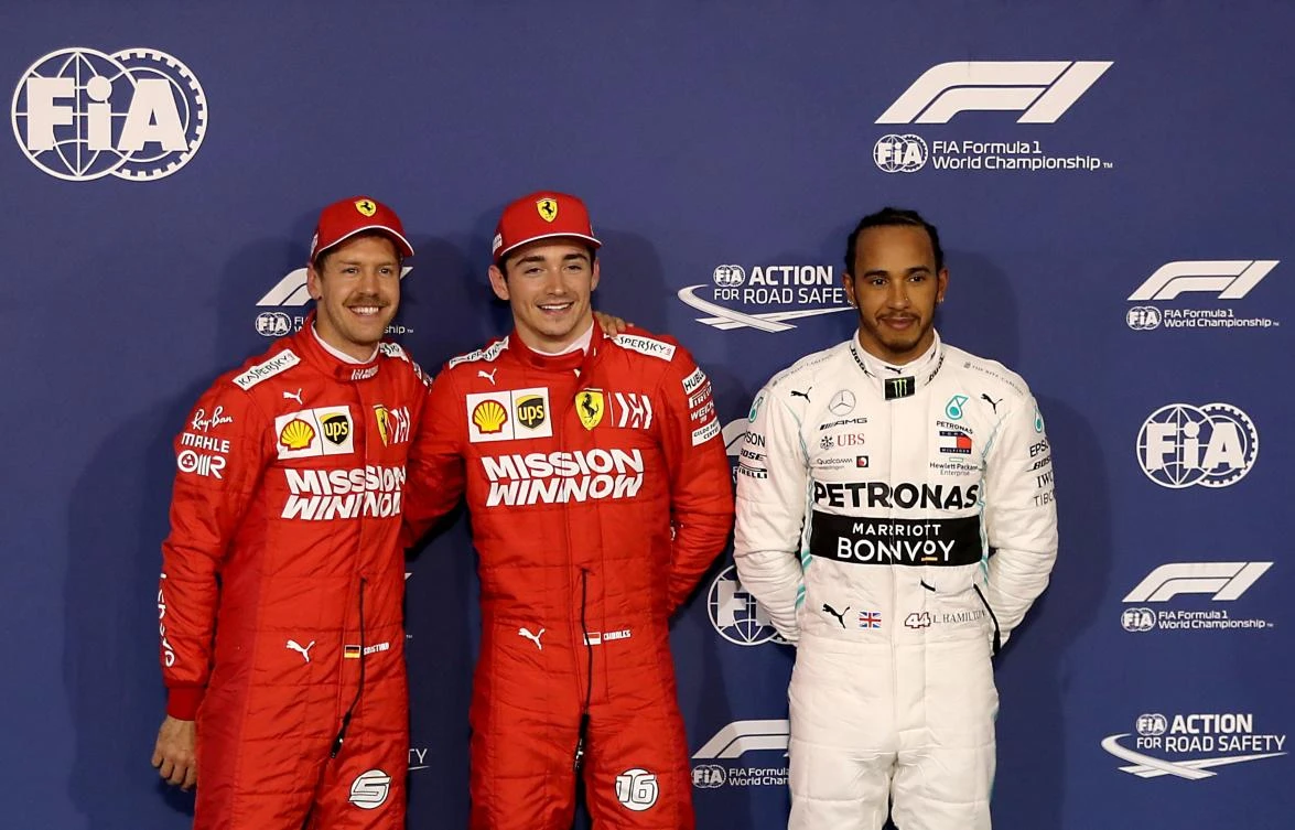Ferrari's German driver Sebastian Vettel (L), Ferrari's Monegasque driver Charles Leclerc (C) and Mercedes' British driver Lewis Hamilton (R) pose for a photograph after the qualifying session ahead of the Formula One Bahrain Grand Prix at the Sakhir circuit. (AFP)
