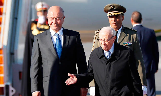 Tunisian President Beji Caid Essebsi (R) welcomes his Iraqi counterpart Barham Salih upon his arrival at Tunis-Carthage international airport on March 30, 2019, to attend the Arab Summit tomorrow. (AFP)