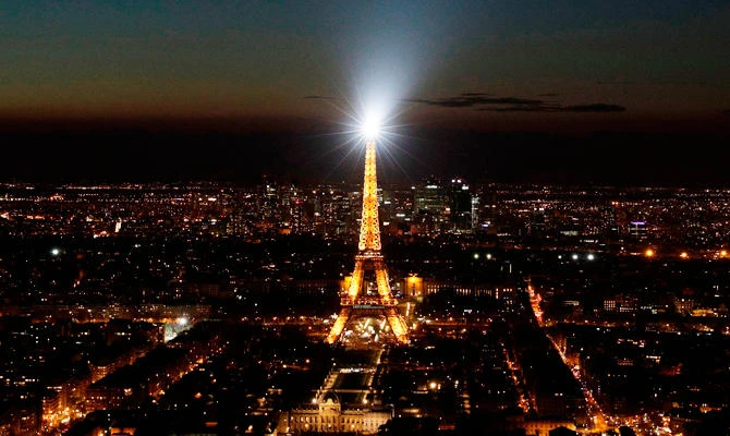 A photo taken on March 30, 2019 shows the Eiffel Tower illuminated, in Paris, before being switched-off for the a Earth Hour organised by the green group WWF. (AFP)