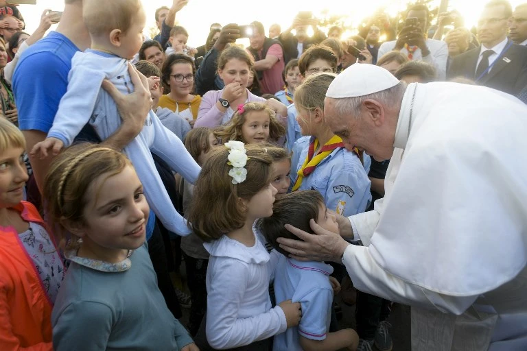 Students greet Pope Francis upon his arrival at the Apostolic Nunciature of the Holy See in Rabat on Saturday, March 30. (Vatican Media/AFP)