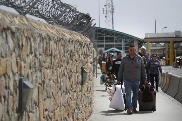 Right now, about 60 asylum seekers a day are returned to Mexico at the San Ysidro, Calexico and El Paso ports to wait out their cases. (AFP)