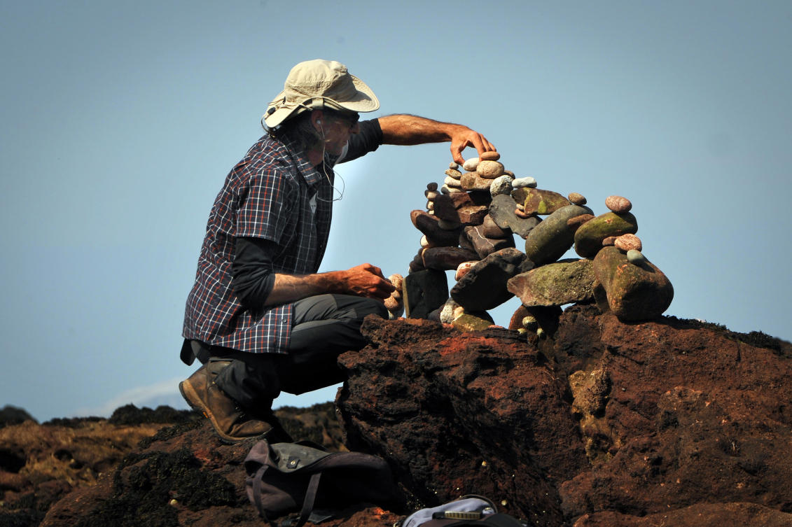 Pedro Duran from Spain competes in the European Stone Stacking Championships 2019 in Dunbar, Scotland, on April 21, 2019. The European Stone Stacking Championships are Europe’s largest championships for all Stone Stacking and Rock Balancing artists and practitioners. Stackers compete in four competitions creating sculptures using stones and balancing them using only the force of gravity. The overall winner receives a trip to llano Earth Art Festival and World Stone Balancing competition 2020. / AFP / Andy Buchanan