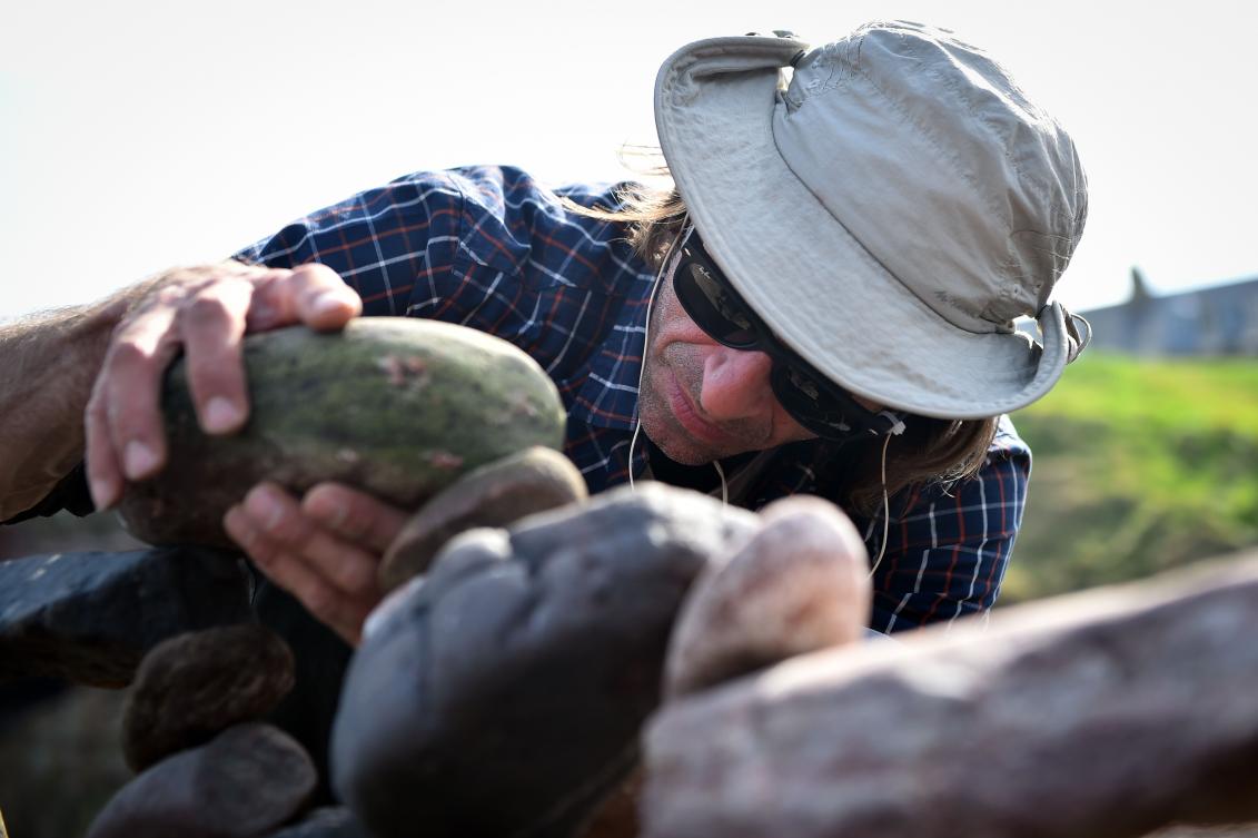 Pedro Duran from Spain competes in the European Stone Stacking Championships 2019 in Dunbar, Scotland, on April 21, 2019. The European Stone Stacking Championships are Europe’s largest championships for all Stone Stacking and Rock Balancing artists and practitioners. Stackers compete in four competitions creating sculptures using stones and balancing them using only the force of gravity. The overall winner receives a trip to llano Earth Art Festival and World Stone Balancing competition 2020. / AFP / Andy Buchanan