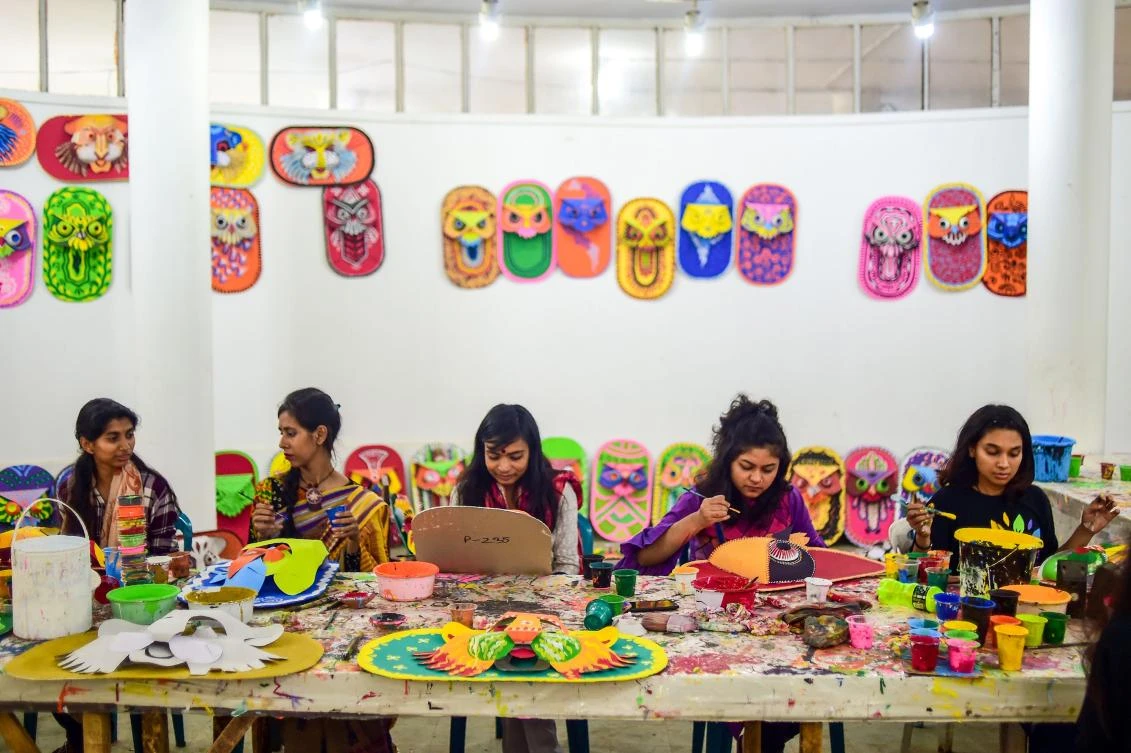 Bangladeshi students of Dhaka University Art Institute paint masks to sell as a part of Bengali New Year preparations in Dhaka on April 7, 2019. The Bengali calendar is solar, with the year beginning on Pohela Boishakh, which falls on April 14 this year, in Bangladesh. / AFP / Munir UZ ZAMAN