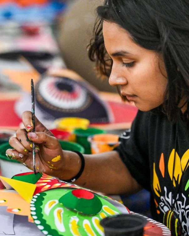 A Bangladeshi student of Dhaka University Art Institute paints a mask to sell as a part of Bengali New Year preparations in Dhaka on April 7, 2019. The Bengali calendar is solar, with the year beginning on Pohela Boishakh, which falls on April 14 this year, in Bangladesh. / AFP / Munir UZ ZAMAN