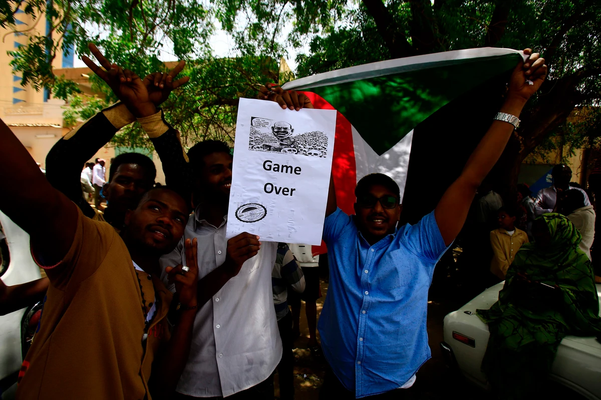 Sudanese demonstrators gather in a street in central Khartoum on April 11, 2019, immediately after one of Africa's longest-serving presidents was toppled by the army. (AFP)