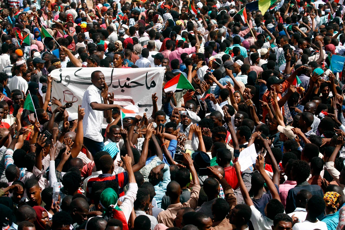 Sudanese demonstrators gather in a street in central Khartoum on April 11, 2019, immediately after one of Africa's longest-serving presidents was toppled by the army. (AFP)