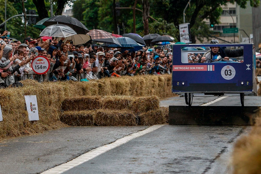 A team competes in the Red Bull Soapbox race in Sao Paulo, Brazil on April 14, 2019. The Red Bull Soapbox race is an annual event where amateur drivers race with their homemade soapbox vehicles down a 420 m hill through obstacles. / AFP / Miguel SCHINCARIOL