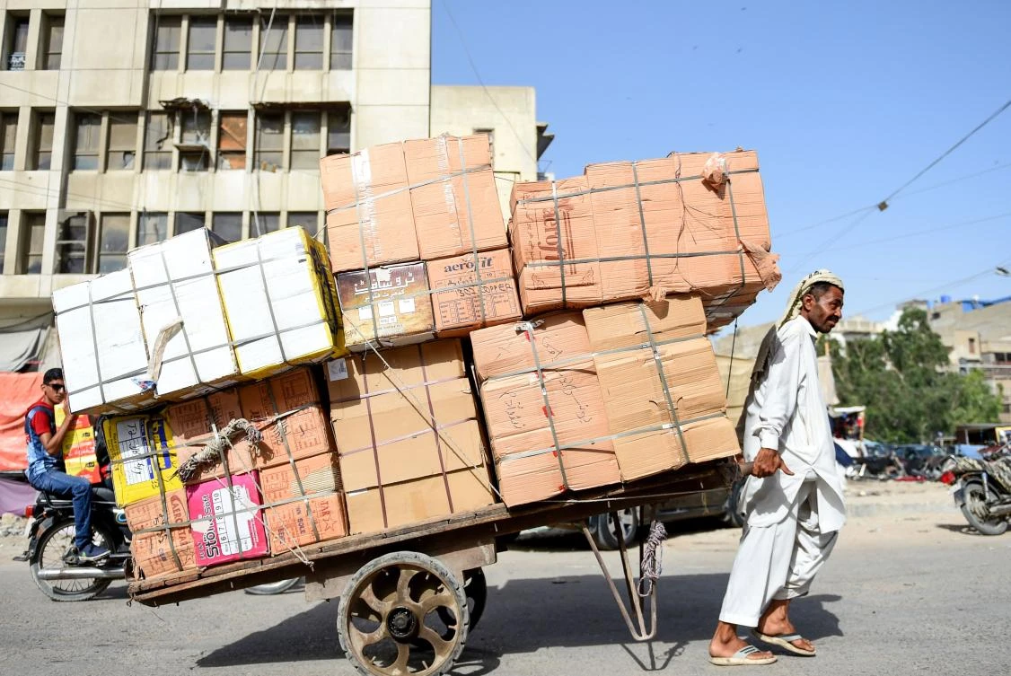A Pakistani labourer pulls a loaded cart on a street in Karachi on April 30, 2019, on the eve of the International Labour Day celebrated on May 1. / AFP / RIZWAN TABASSUM