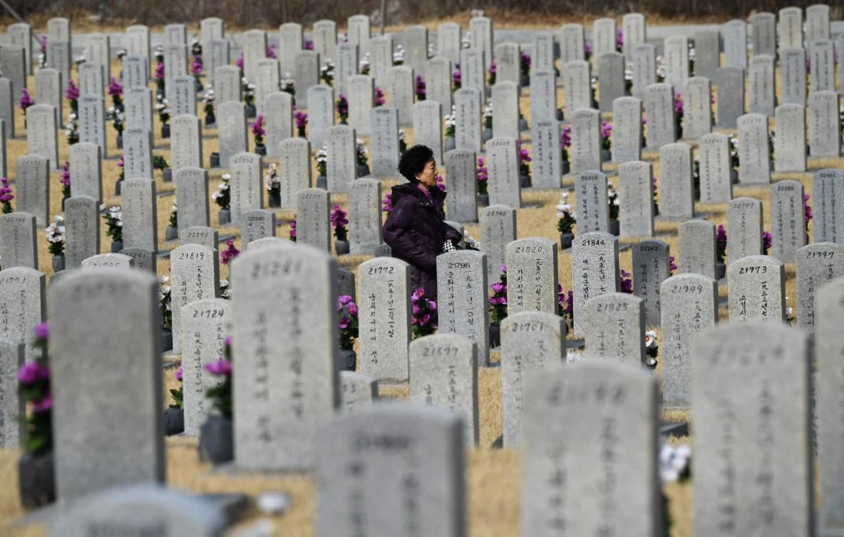 A woman walks past gravestones of South Korean soldiers killed in the 1950-53 Korean War, at the National Cemetery in Seoul on February 27, 2019. (File/AFP)