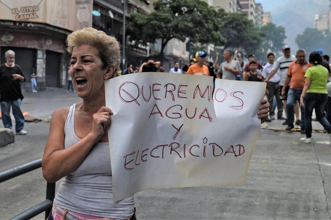Angry Venezuelans took to the streets of Caracas to protest the power cuts and water shortages. (AFP)