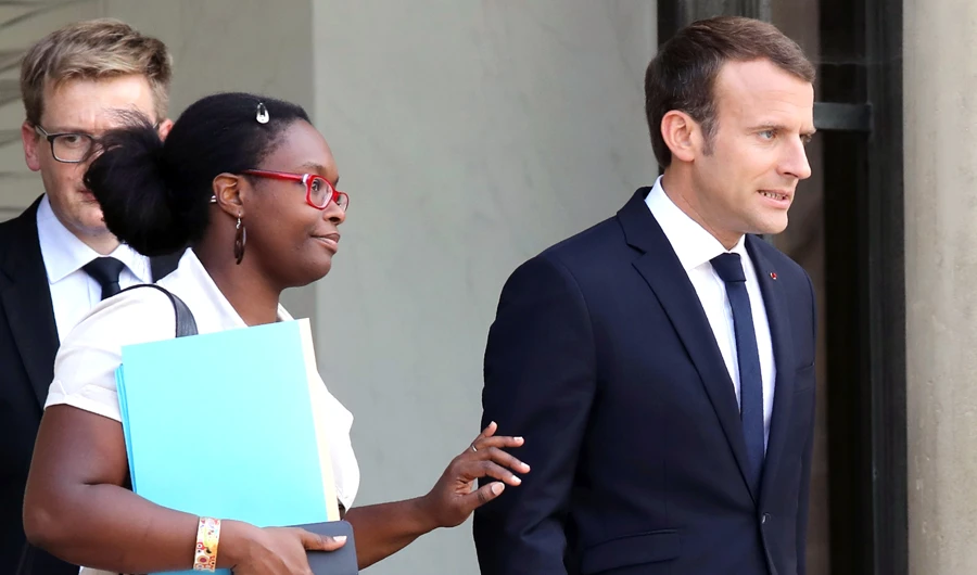 In this file photo, Sibeth Ndiaye (L) and French president Emmanuel Macron leave the Elysee palace, in Paris. (AFP)