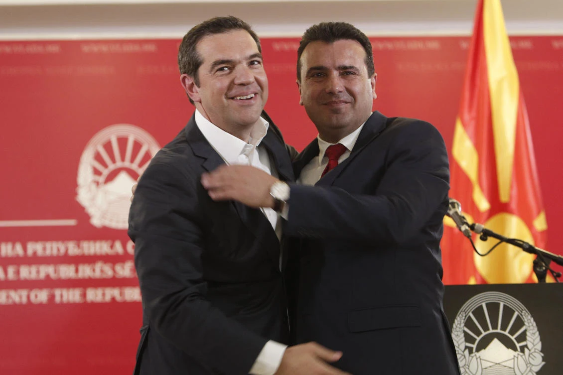 Greek Prime Minister Alexis Tsipras, left, embraces his North Macedonian counterpart Zoran Zaev, during a joint news conference in Skopje, North Macedonia. (AP Photo)