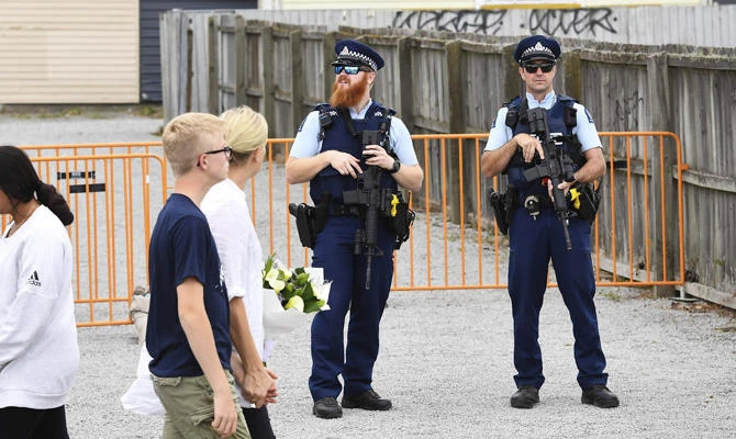 Policemen stand guard outside the Linwood Islamic Centre which remains closed despite the reopening of city's Al Noor mosque, in Christchurch on March 23, 2019. (AFP)