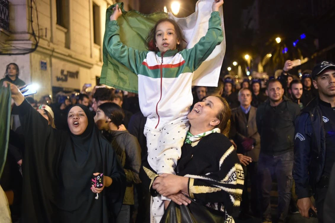Algerians celebrate after Algeria's veteran President Abdelaziz Bouteflika informed the Constitutional Council that he is resigning, in Algiers on April 2, 2019. (AFP)