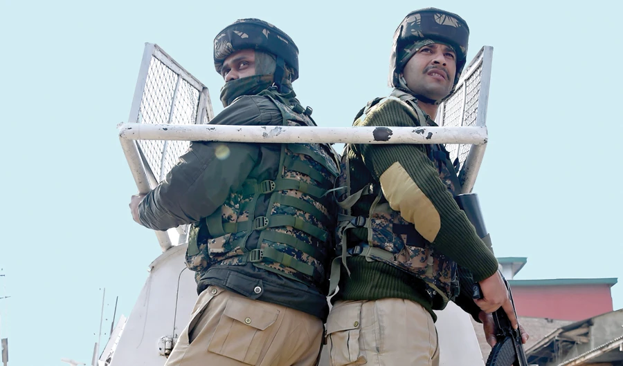 Indian soldiers patrol outside a central jail in Srinagar after riots broke out in the prison. (AFP)