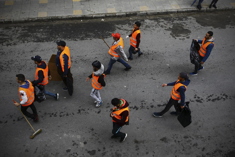 InGroups of young people roam the streets picking up bottles and other detritus after Algeria's weekly pro-democracy protests, in a powerful demonstration of the movement's peaceful, hopeful spirit. (AP Photo/Fateh Guidoum)