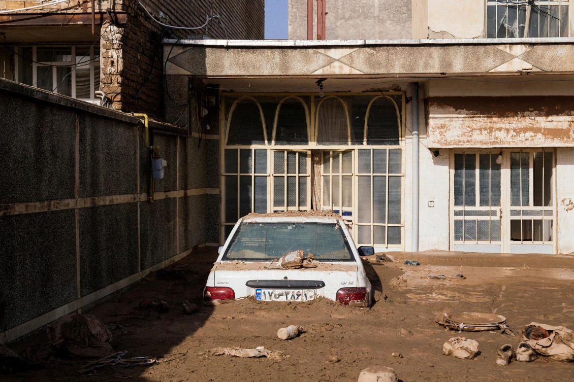 A car half-covered with mud is seen at a house in Lorestan province, Iran, April 4, 2019. (Reuters)