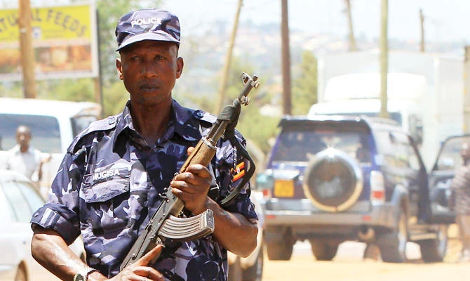 An Ugandan policeman holds his weapon during an arrest of people suspected of murdering Joan Kagezi, a senior Ugandan prosecutor, on the outskirts of Uganda's capital Kampala April 7, 2015. (REUTERS)