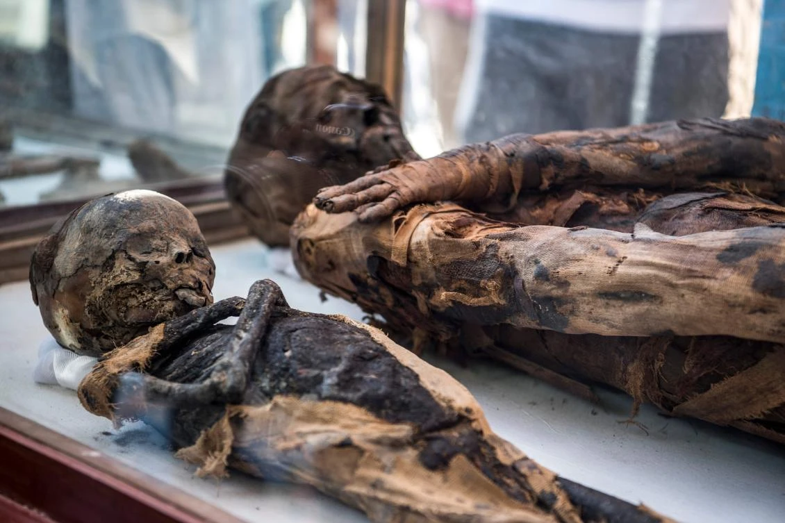 This picture taken on April 5, 2019 mummies on display outside a newly-discovered tomb dating to the Ptolemaic era (323-30 BC) at the Diabat necropolis near the city of Akhmim in Egypt's southern Sohag province, about 500 kilometres south of the capital Cairo. (AFP)