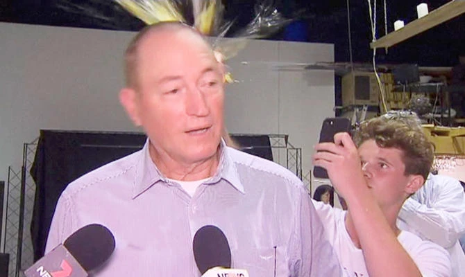 In this March 16, 2019, file image made from video, a teenager breaks an egg on the head of Senator Fraser Anning while he holds a press conference, in Melbourne. (AP)