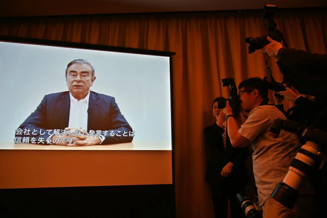 Journalists look on as a video of former Nissan chief Carlos Ghosn is played during a press conference on Tuesday, April 9, 2019. (AFP)