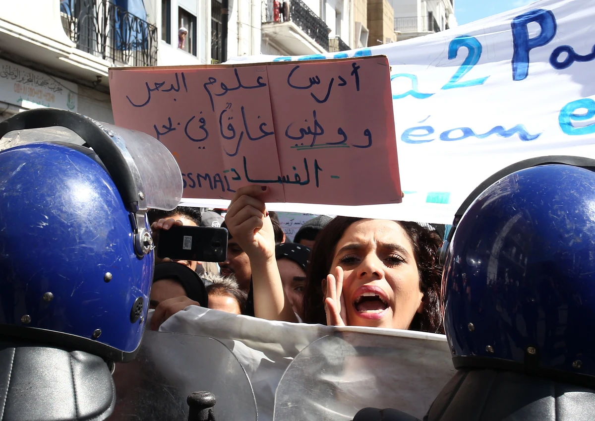 A student carries a placard that reads in Arabic “... my country is drowning in a sea of corruption” during a demonstration in Algiers on Tuesday, April 9, 2019. (AFP)