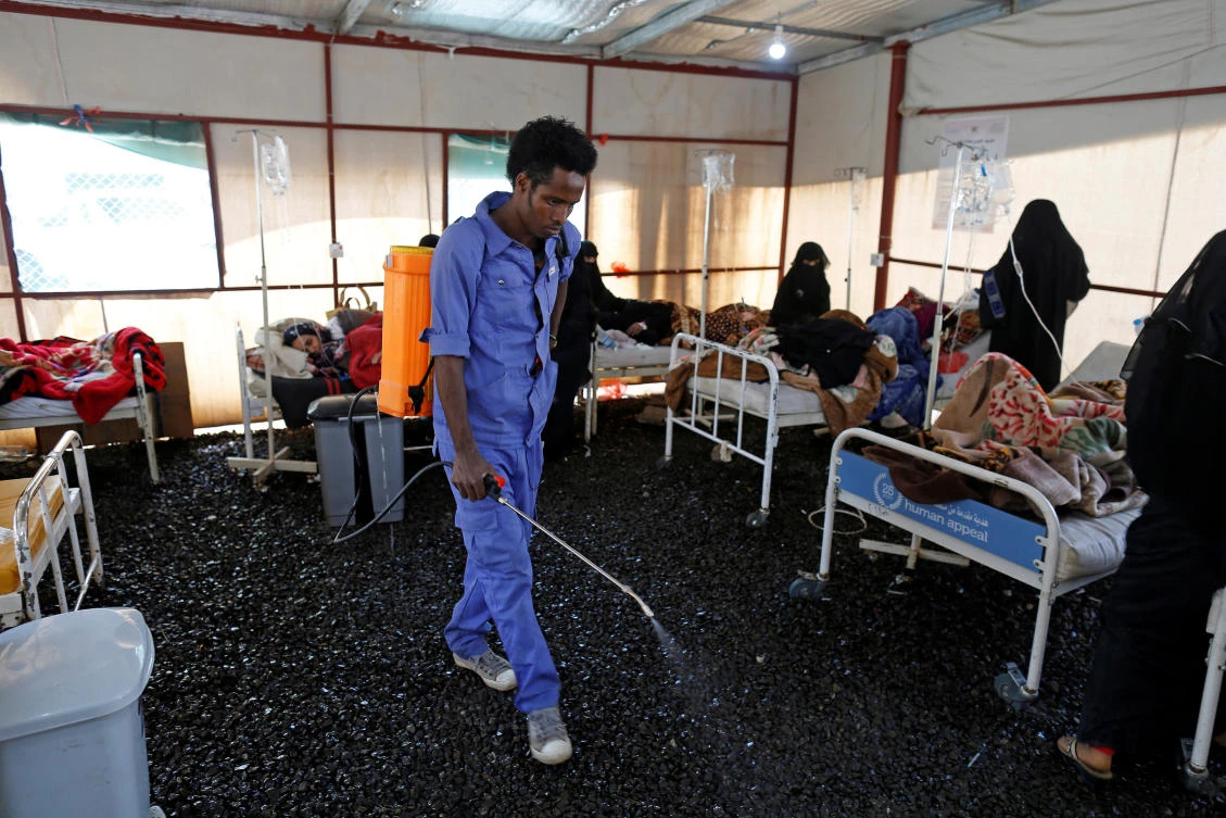 A worker sprays pesticides inside a tent where patients receive medical care at a cholera treatment center in Sanaa in March, 2019. (Reuters/File Photo)