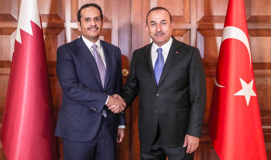 Turkey's minister for Foreign Affairs Mevlut Cavusoglu (R) shaking hands with Qatari Deputy Prime Minister and minister for Foreign Affairs Mohammed bin Abdulrahman Al-Thani. (AFP)