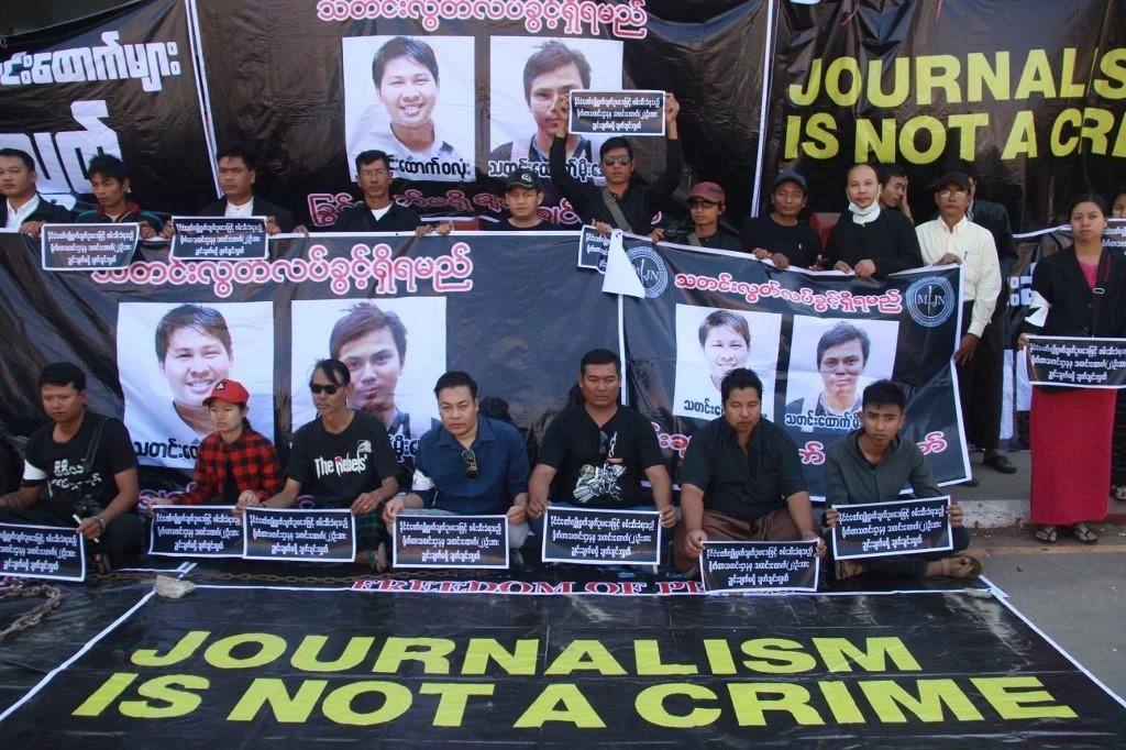 Journalists stage a protest to demand the release of Reuters journalists Wa Lone and Kyaw Soe Oo (pictured in posters behind) in Pyaye, Myanmar on December 27, 2017. (AFP)
