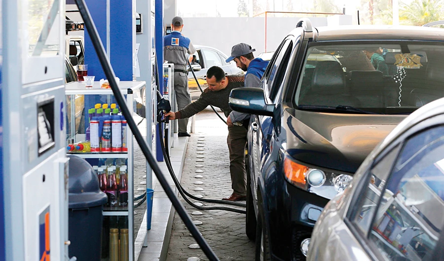 Syrians queue to fill their car with gasoline at a station in Damascus. (AFP)
