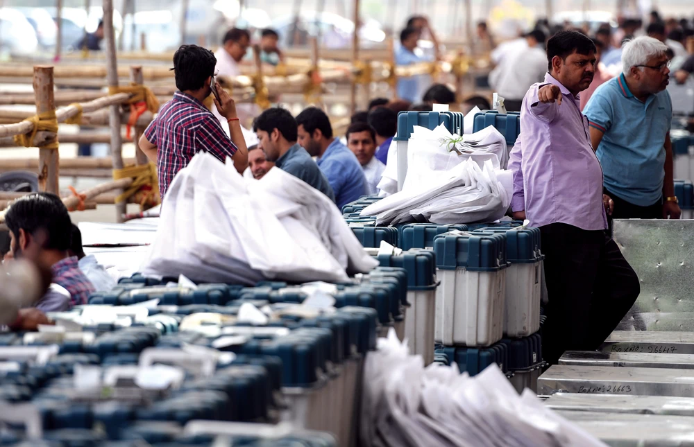 Indian officials prepare election-related material at a distribution centre in Noida in India’s northern state of Uttar Pradesh on Wednesday. (AFP)